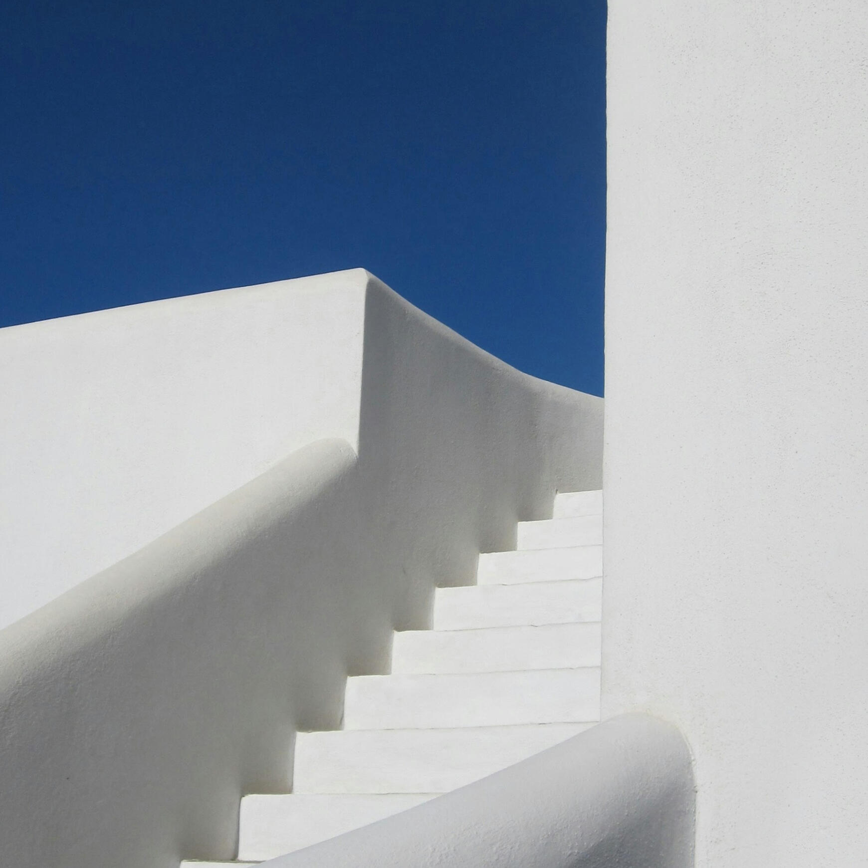 Photo by Sigmund on Unsplash white stairs with a blue sky as the background